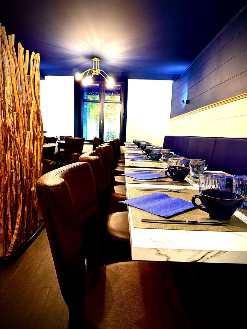 The long table, set in front of the windows